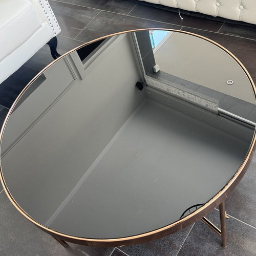 Round coffee table with glass top and metal frame