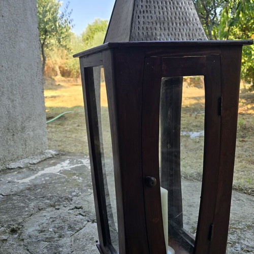 Decorative wooden lantern with metal roof and chimney