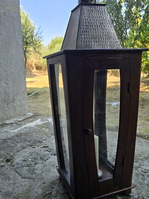 Decorative wooden lantern with metal roof and chimney