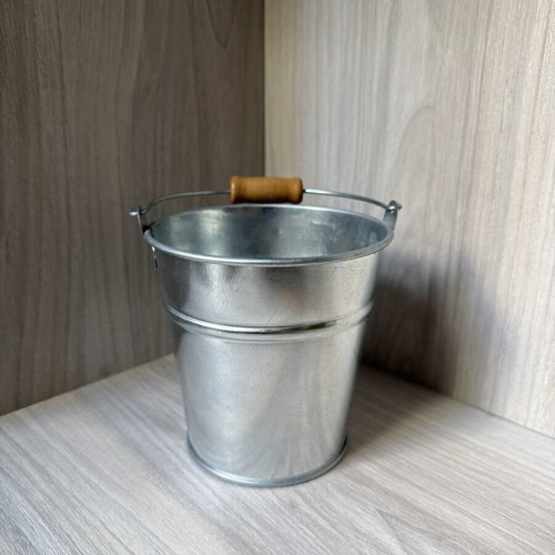 Decorative galvanized metal bucket with wooden handle