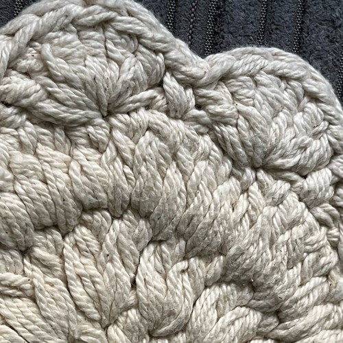 Knitted coaster used, flower-shaped, beige