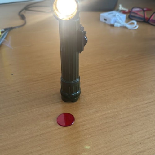 Handheld and pocket flashlight used, with clip and red filter