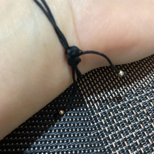 Bracelet with cord and silver pendant like new