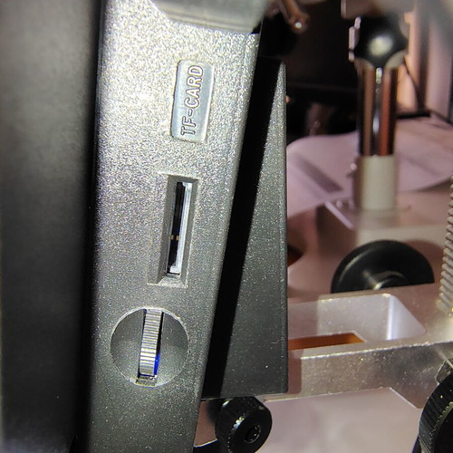 Digital bench microscope with adjustable height and built-in lighting