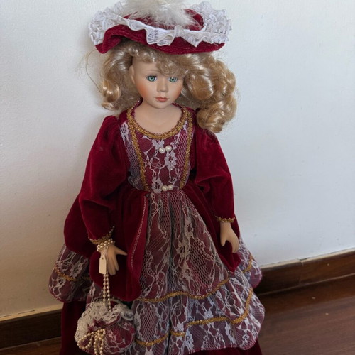 Porcelain doll with burgundy velvet dress like new