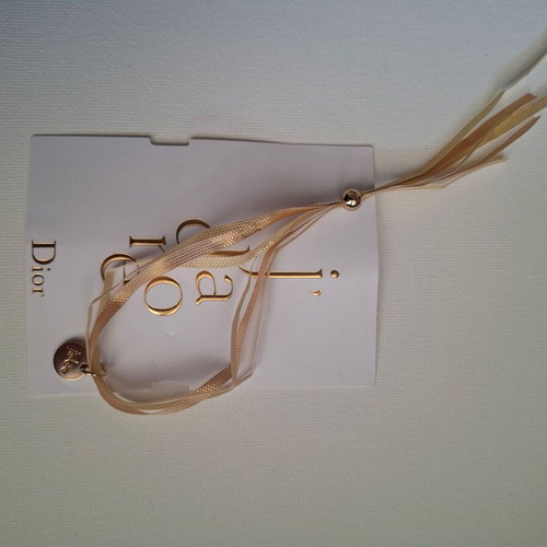Dior bracelet with charm and adjustable ribbon new, gold and beige