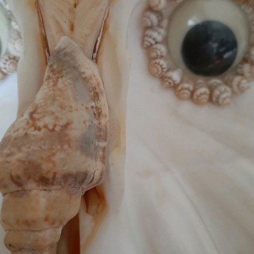 Decorative owl figurine made of large shells used