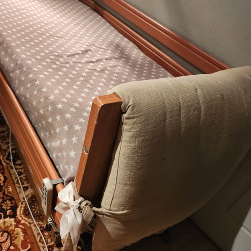 Electric hospital bed used with headboard
