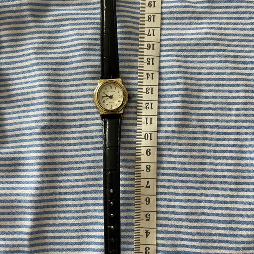 Citron wristwatch used with gold color and black strap