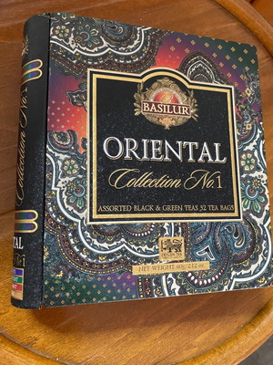 Metal book-shaped tin box with embossed designs