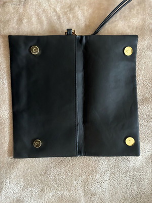 Handheld black clutch bag like new with leather detail