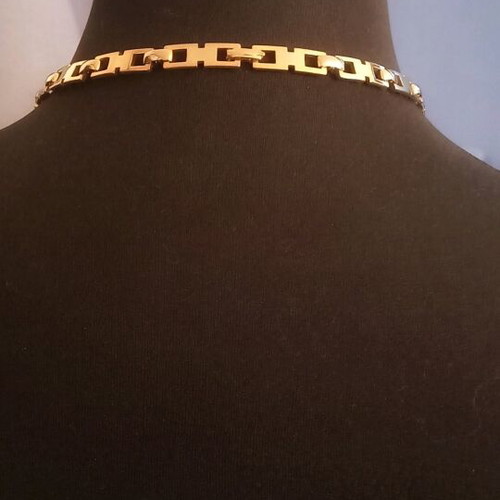 Necklace like new, gold color with white and red stones