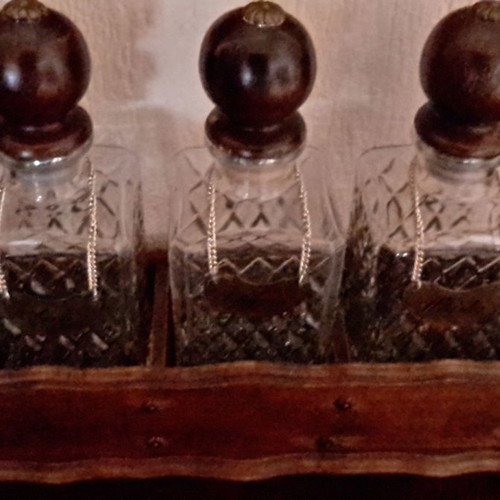 Vintage English decanters used in wooden stand for gin, cognac, whisky