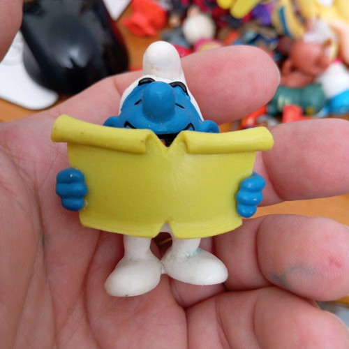 Smurf figure used reading a book