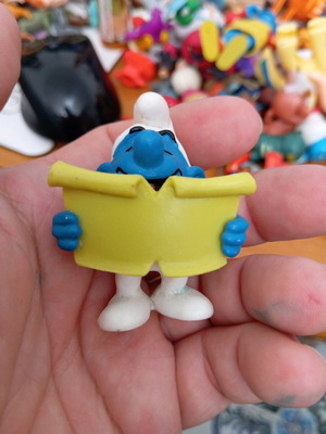 Smurf figure used reading a book