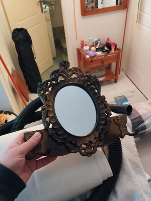 Vintage face mirror with hooks used