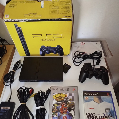 PlayStation 2 console with original controller, memory card and 2 games