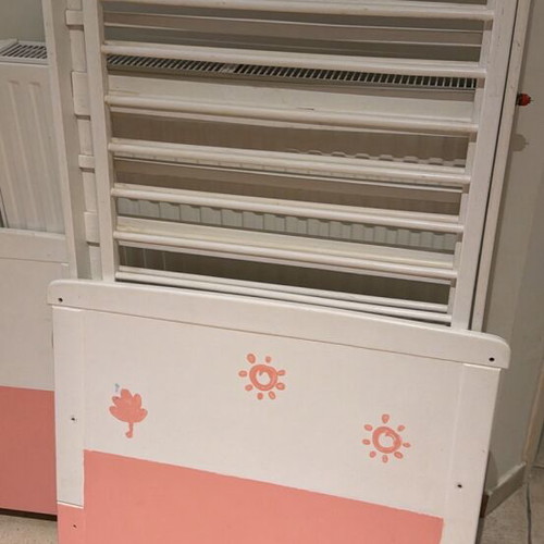 Wooden baby cot, white and pink with side rails