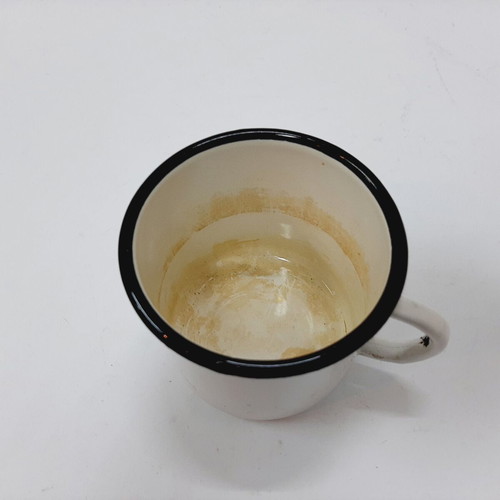 Vintage enamel metal mug with floral motif