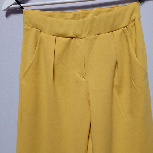 Yellow fabric pants used with elastic waist and pockets