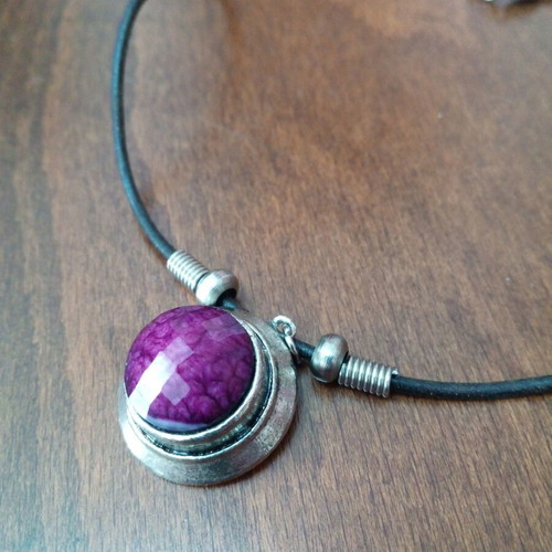 Pendant with purple glass cabochon on leather strap used