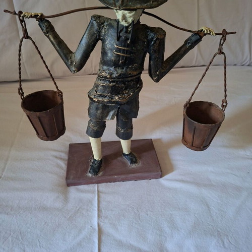 Asian Water Carrier Decorative Figurine like new, metal with wooden base