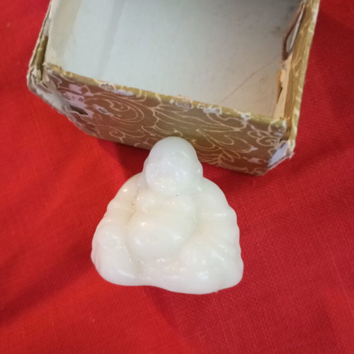 Alabaster-style miniature Buddha, smiling