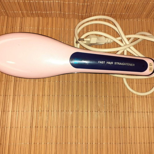 Electric hair straightening brush used