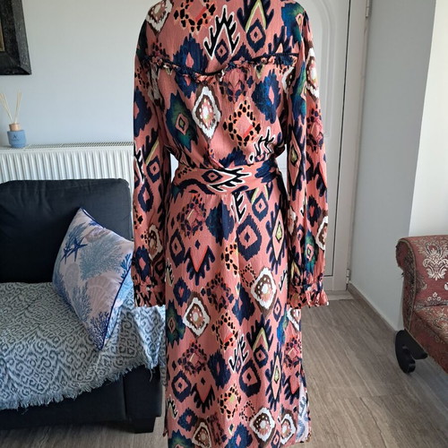 Pom dress used with geometric pattern in pink, blue and green