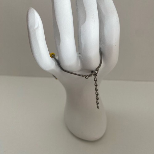 Silver bracelet used with orange and yellow beads