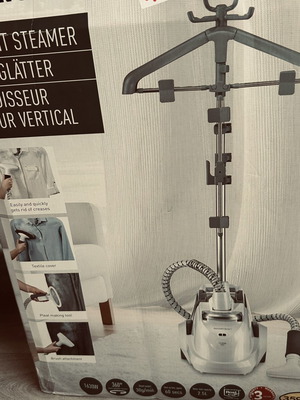 Vertical garment steamer with hanger and accessories