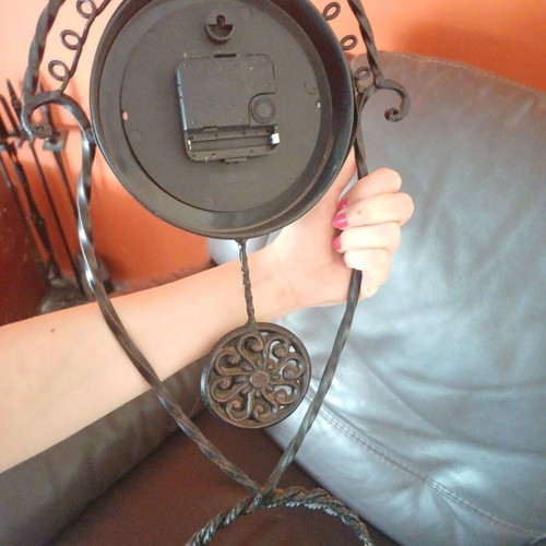 Vintage table clock with pendulum from wrought iron decorative