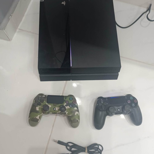 PlayStation 4 console with 2 controllers and cables