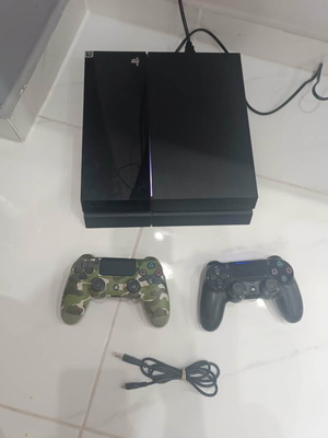 PlayStation 4 console with 2 controllers and cables