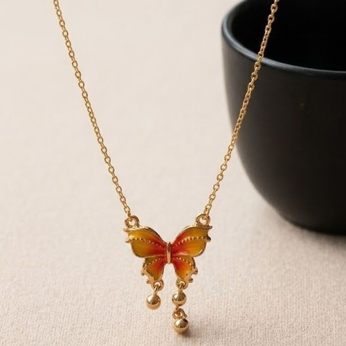 Gold necklace with butterfly, like new, orange accents