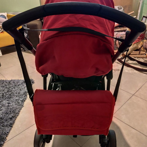 Kiddo Smart Deluxe stroller used with footmuff and changing bag, red