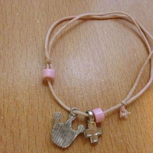 Pink bracelet with beads, cross and crown, used