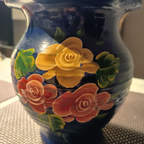 Handmade traditional clay vase with painted flowers