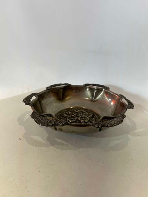 Vintage decorative bowl with embossed flower designs used