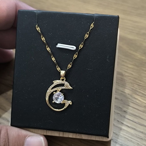 Necklace with dolphins and white stone, gold color