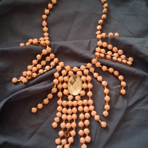 Plastic necklace with rose and gold beads, faux diamond centerpiece