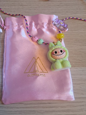 Labunoma necklace with colorful fuzzy smiling monster charm, like new
