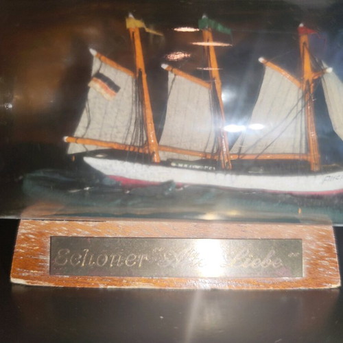 Ship in a bottle used with sealed top and wooden base