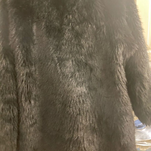 Long-haired fur used, black synthetic with pockets