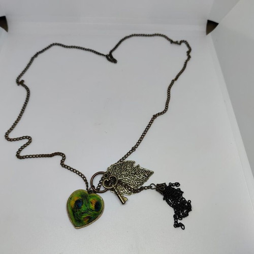 Vintage necklace with antique bronze elements and peacock feather heart pendant like new