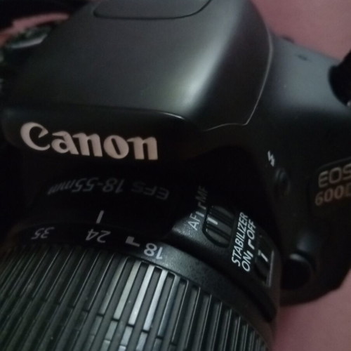 Canon EOS600D camera with 18-55mm lens, strap, charger, and two batteries