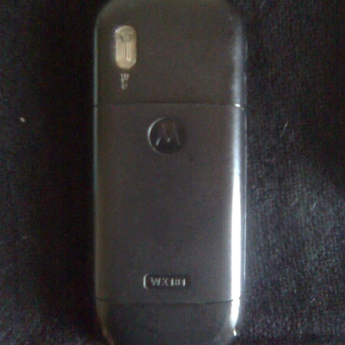 Motorola WX181 like new mobile phone with charger, headphones, and box