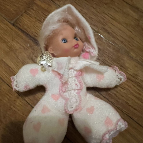 Doll with hood, missing one leg and one arm, slight tear