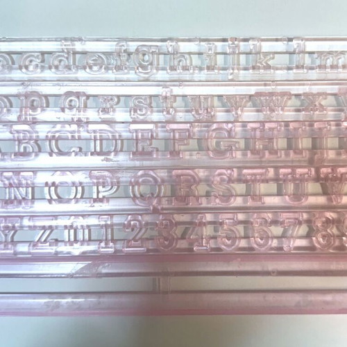 Set of letter and number cutters like new, transparent plastic