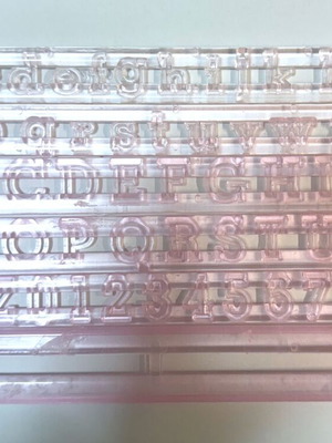 Set of letter and number cutters like new, transparent plastic